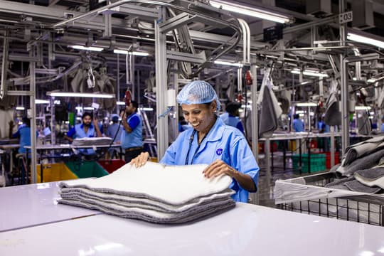 Smiling worker in a modern textile factory